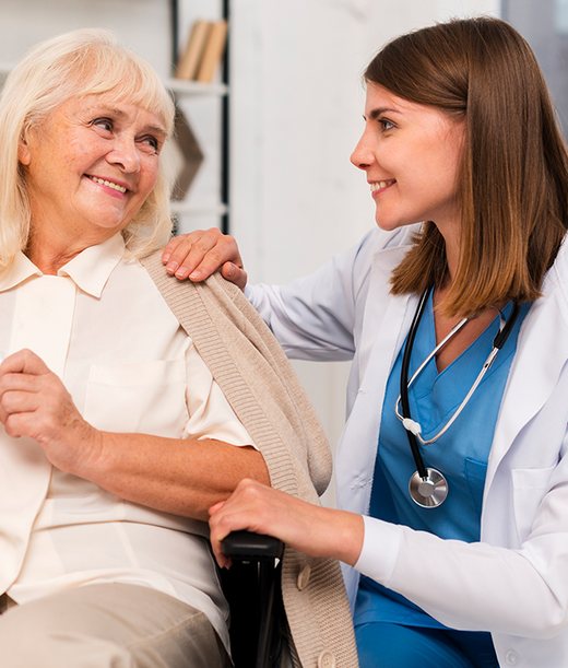 Doctor chatting warmly with an older woman