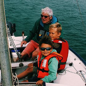 Grandfather sailing with his grandsons