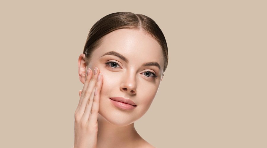 Woman touching her fresh, glowing skin