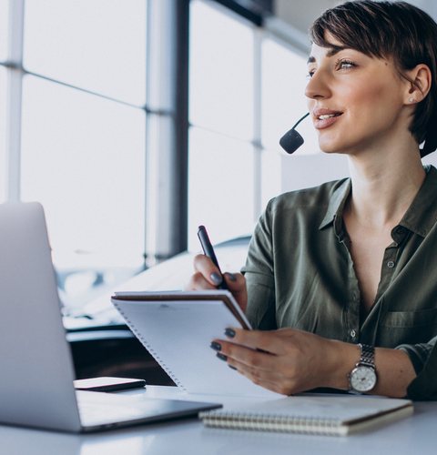Friendly patient advisor answering calls at her desk