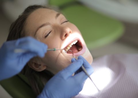 Dentist gently examining a patient's teeth