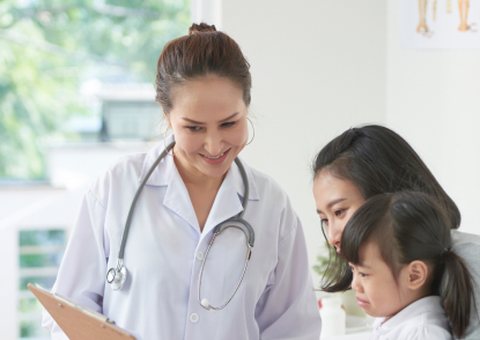 Doctor talking with a mother and her young daughter