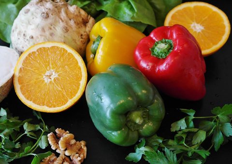 Fresh peppers, oranges, greens and walnuts